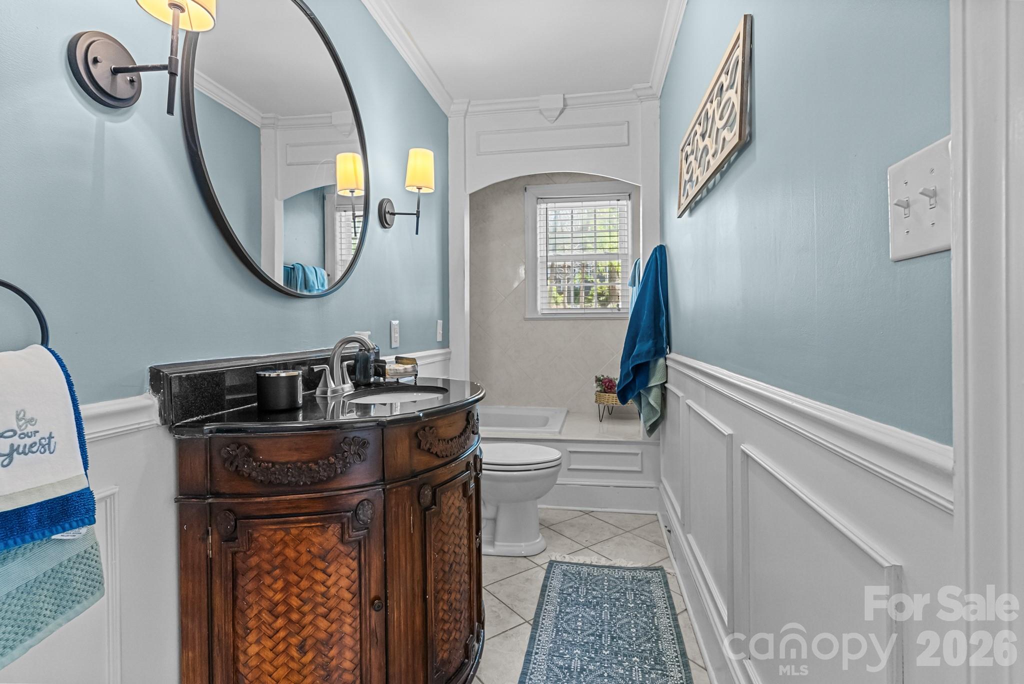211 Dutchman Creek Road Elkin, NC 28621 - Photo 30 of 48 a bathroom with a sink a mirror a vanity and a window