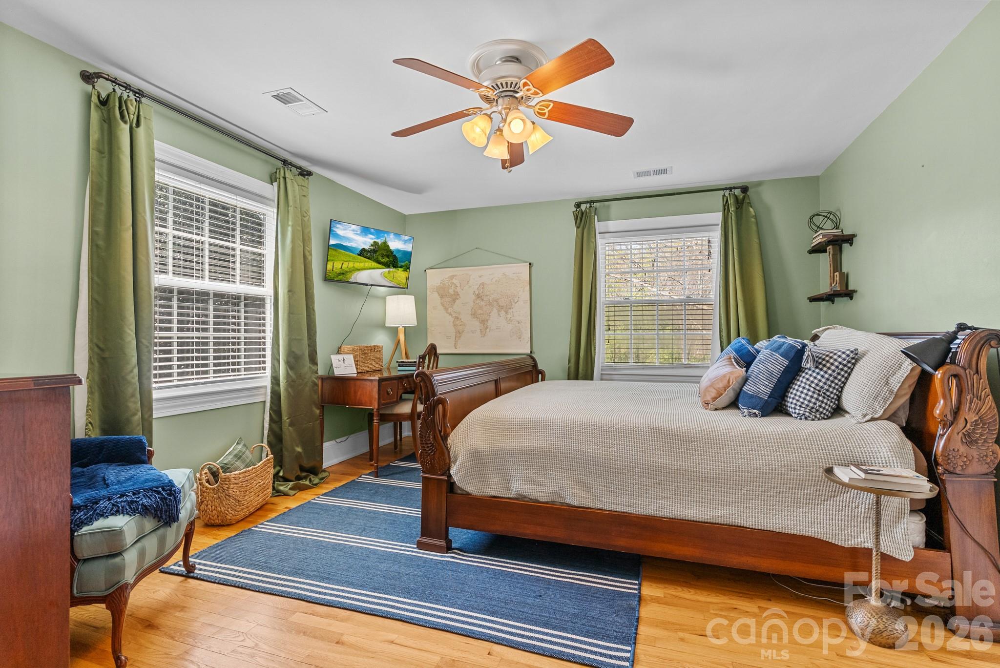 211 Dutchman Creek Road Elkin, NC 28621 - Photo 39 of 48 a bedroom with a bed and wooden floor