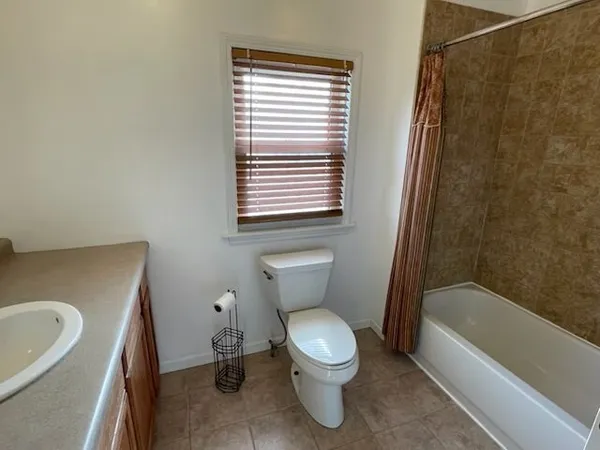 a bathroom with a toilet and a bathtub