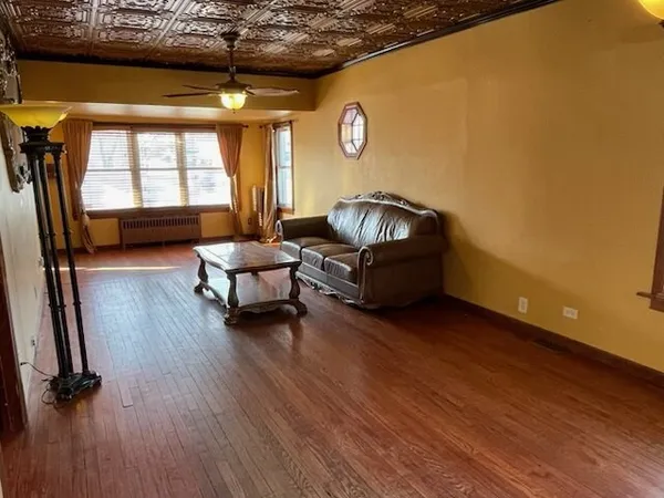 a living room with furniture window and wooden floor