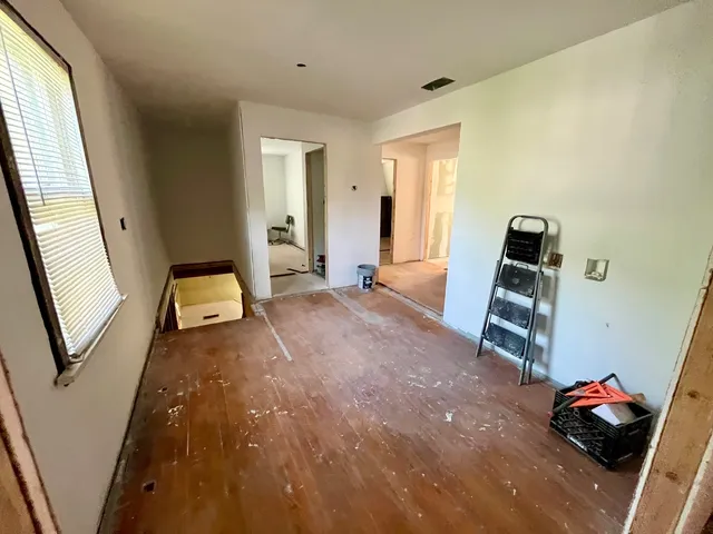 a view of a house with a big yard and large trees