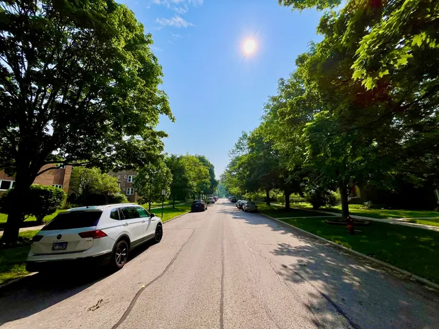a house with a yard and a car park in front of it