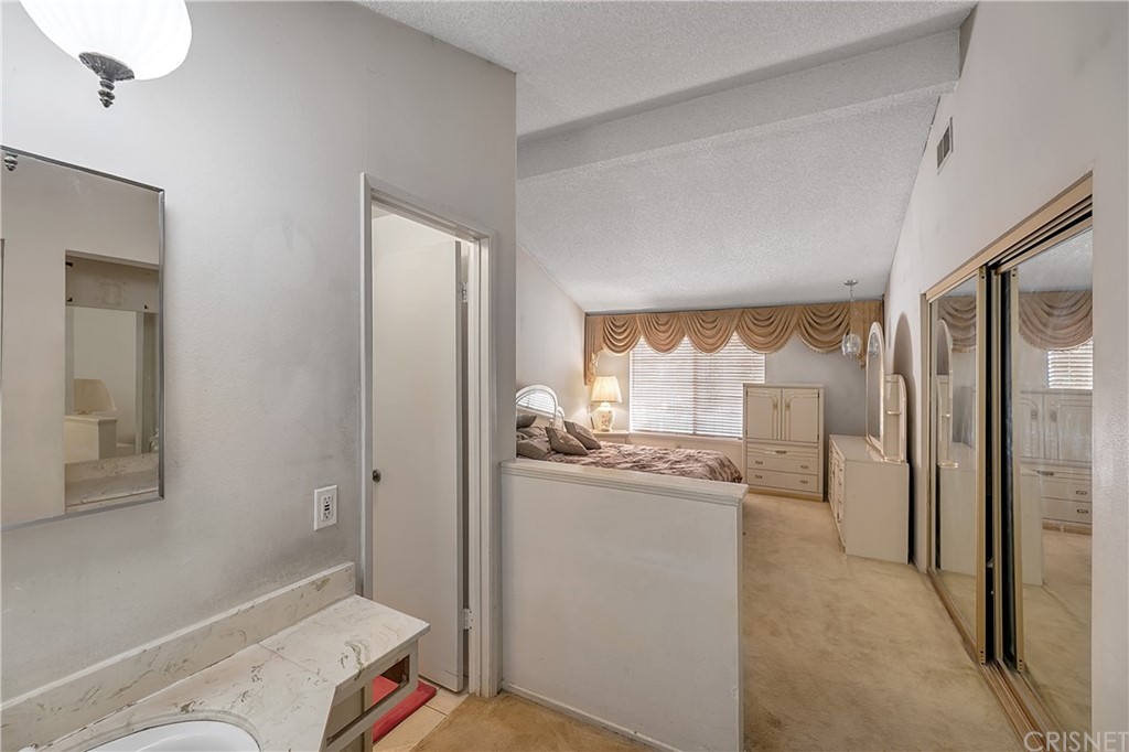 9689 Kewen Avenue Arleta, CA 91331 - Photo 15 of 28 a bathroom with a granite countertop sink mirror and toilet