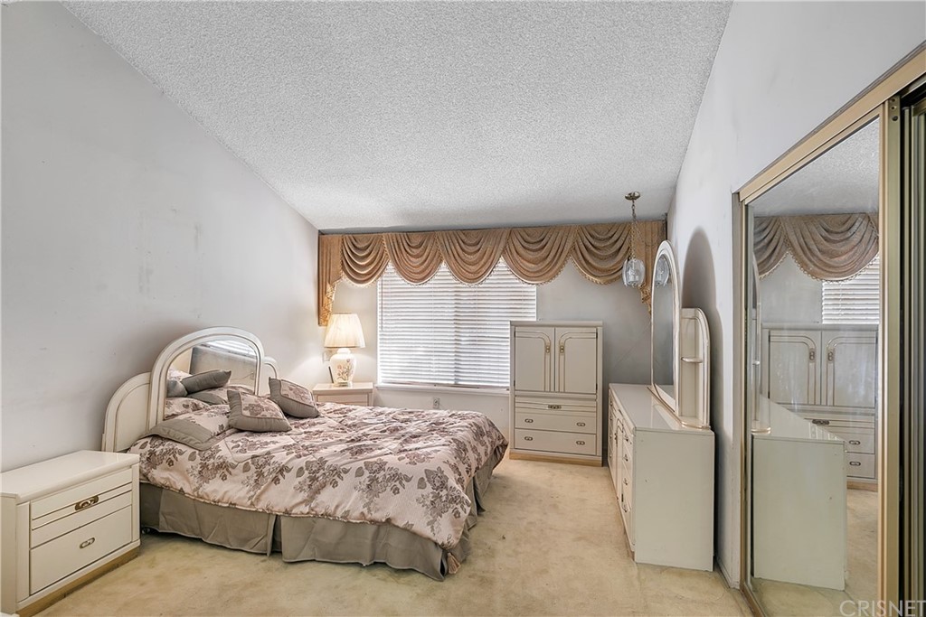 9689 Kewen Avenue Arleta, CA 91331 - Photo 16 of 28 a bedroom with a bed mirror and a window