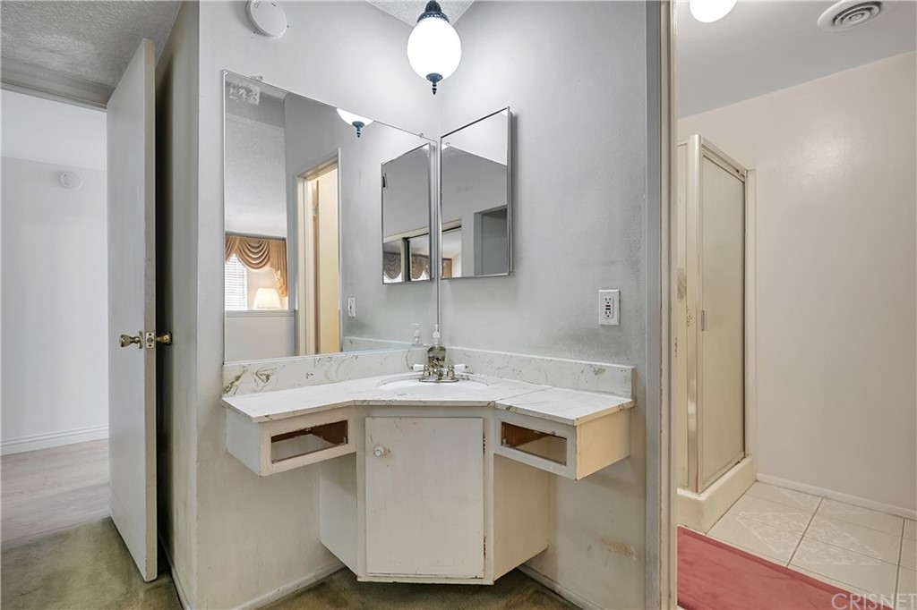 9689 Kewen Avenue Arleta, CA 91331 - Photo 17 of 28 a kitchen with a sink a stove and cabinets