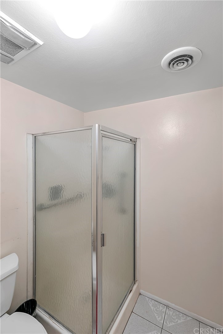 9689 Kewen Avenue Arleta, CA 91331 - Photo 18 of 28 a bathroom with a shower and a toilet