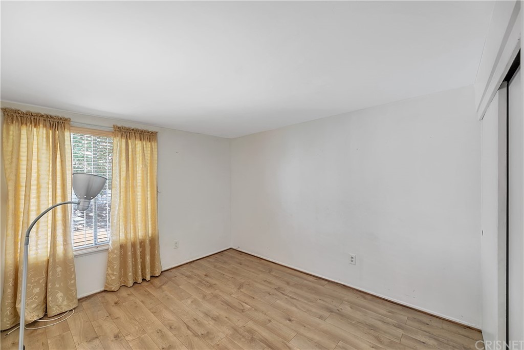 9689 Kewen Avenue Arleta, CA 91331 - Photo 21 of 28 an empty room with wooden floor and windows
