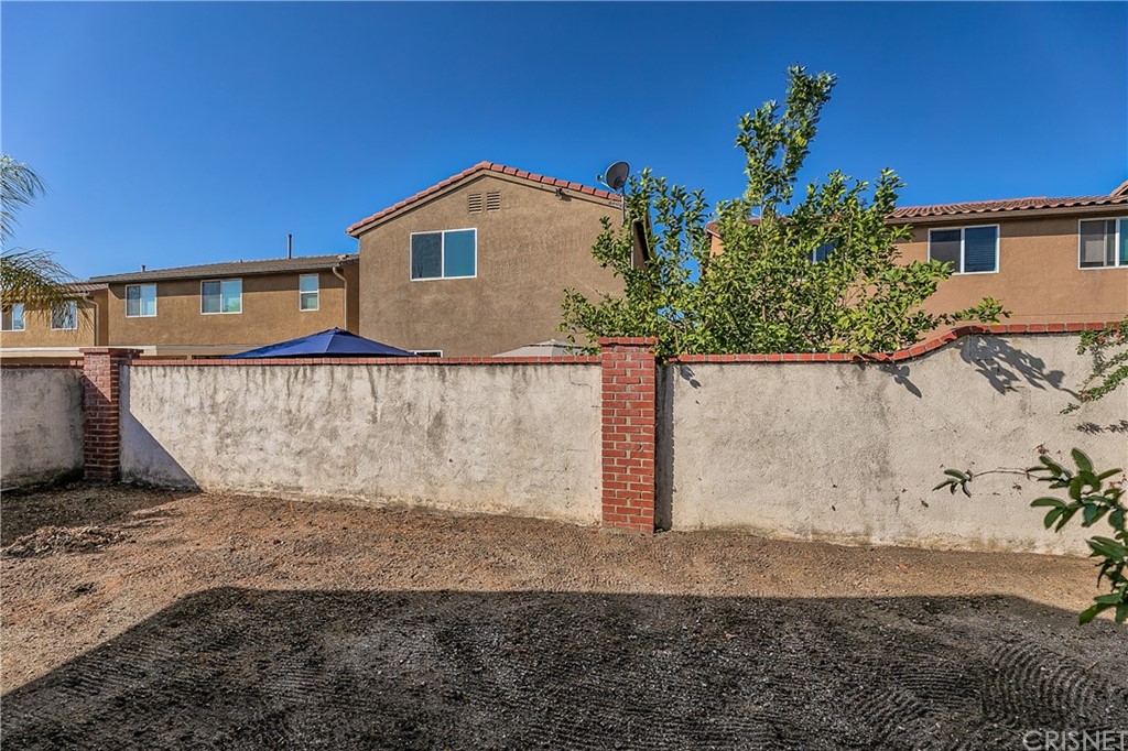 9689 Kewen Avenue Arleta, CA 91331 - Photo 23 of 28 a view of a house with a yard