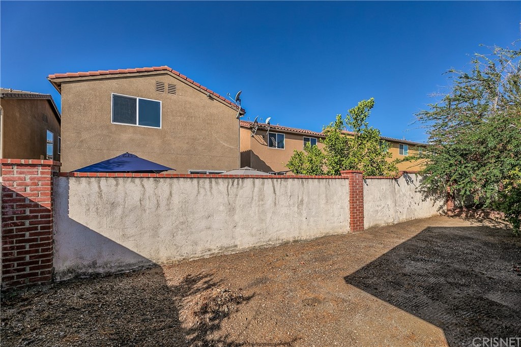 9689 Kewen Avenue Arleta, CA 91331 - Photo 24 of 28 a front view of a house with a yard