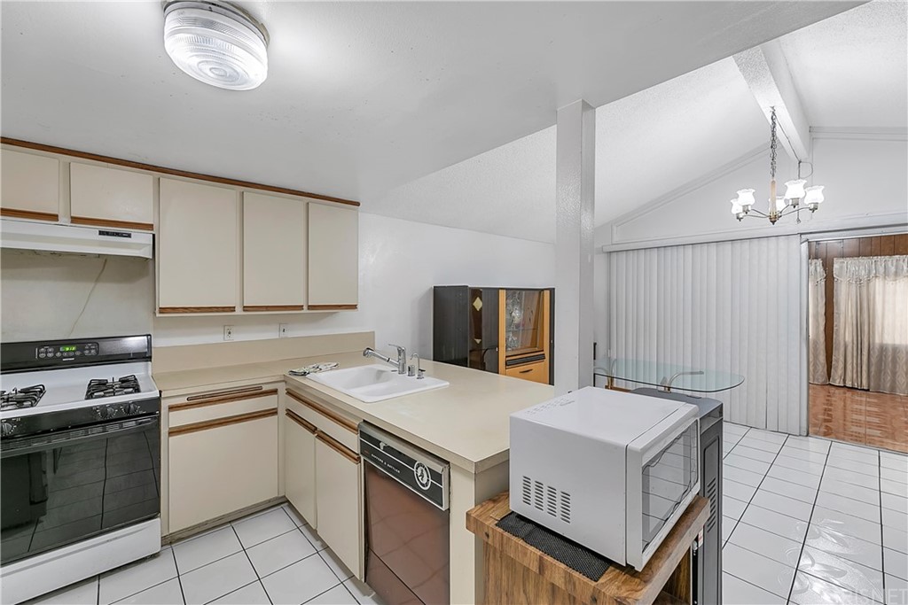 9689 Kewen Avenue Arleta, CA 91331 - Photo 7 of 28 a kitchen with a stove sink and a refrigerator