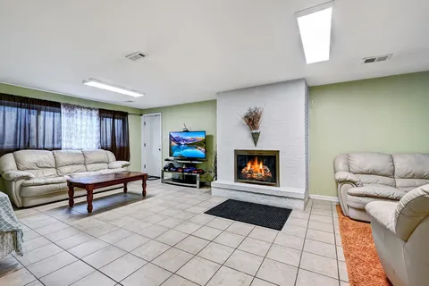 a living room with furniture a flat screen tv and a fireplace