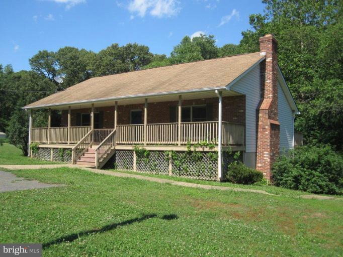 10473 Tetotum Road King George, VA 22485 - Photo 2 of 23 a house that has a big yard with wooden fence