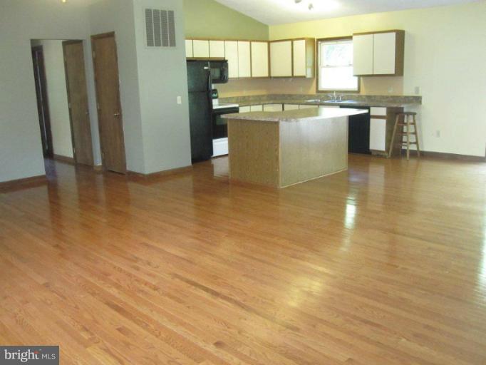 10473 Tetotum Road King George, VA 22485 - Photo 7 of 23 a kitchen with a cabinets and wooden floor