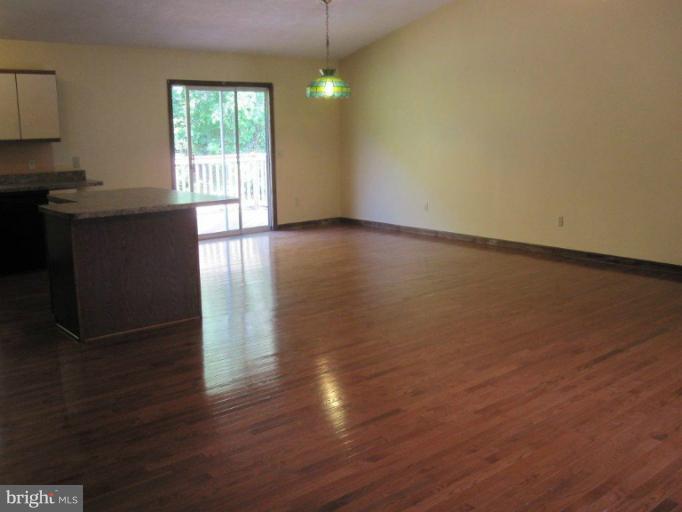 10473 Tetotum Road King George, VA 22485 - Photo 8 of 23 a view of an empty room with wooden floor and a window