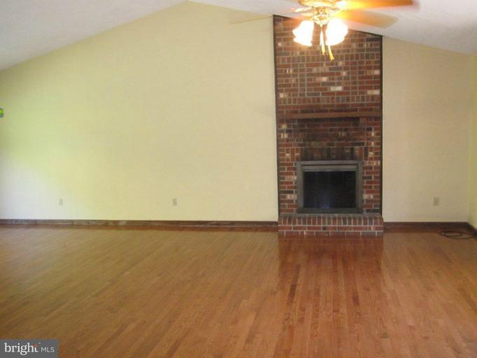 10473 Tetotum Road King George, VA 22485 - Photo 9 of 23 a view of empty room with wooden floor and fan