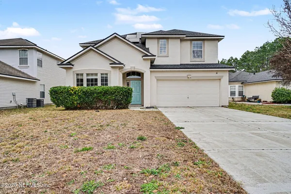 a front view of a house with a yard