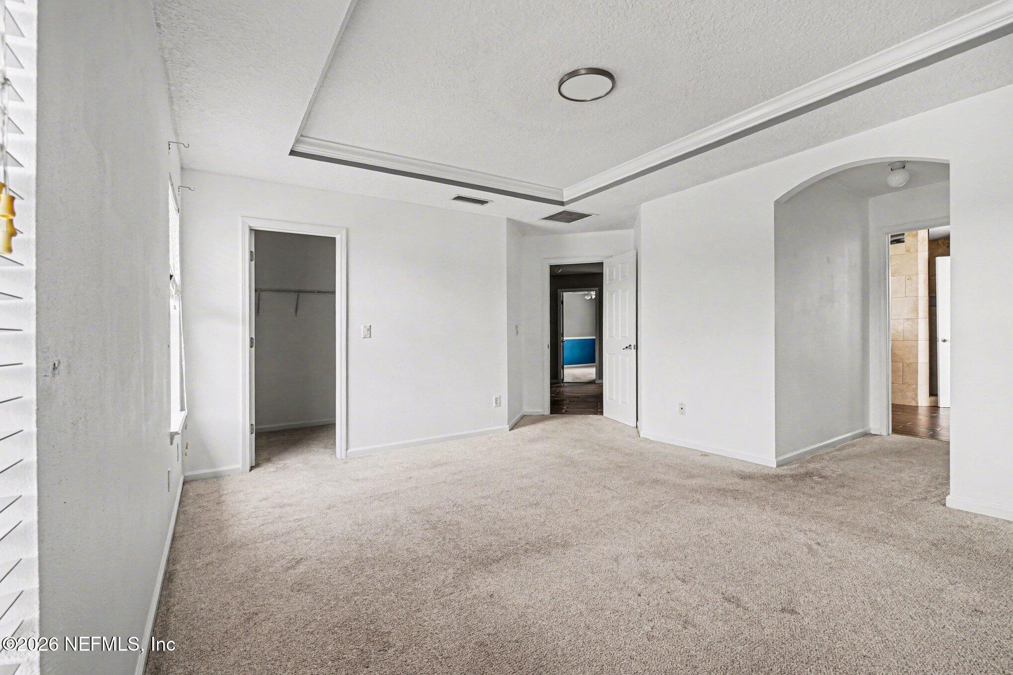 96039 Morton Lane Yulee, FL 32097 - Photo 12 of 27 an empty room with closet and a hallway