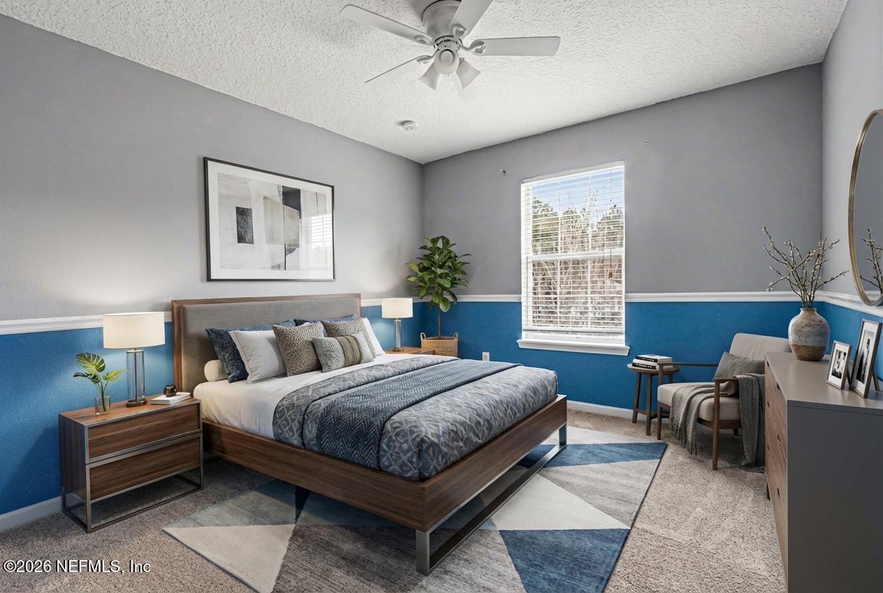 96039 Morton Lane Yulee, FL 32097 - Photo 23 of 27 a bedroom with a bed a couch and a window