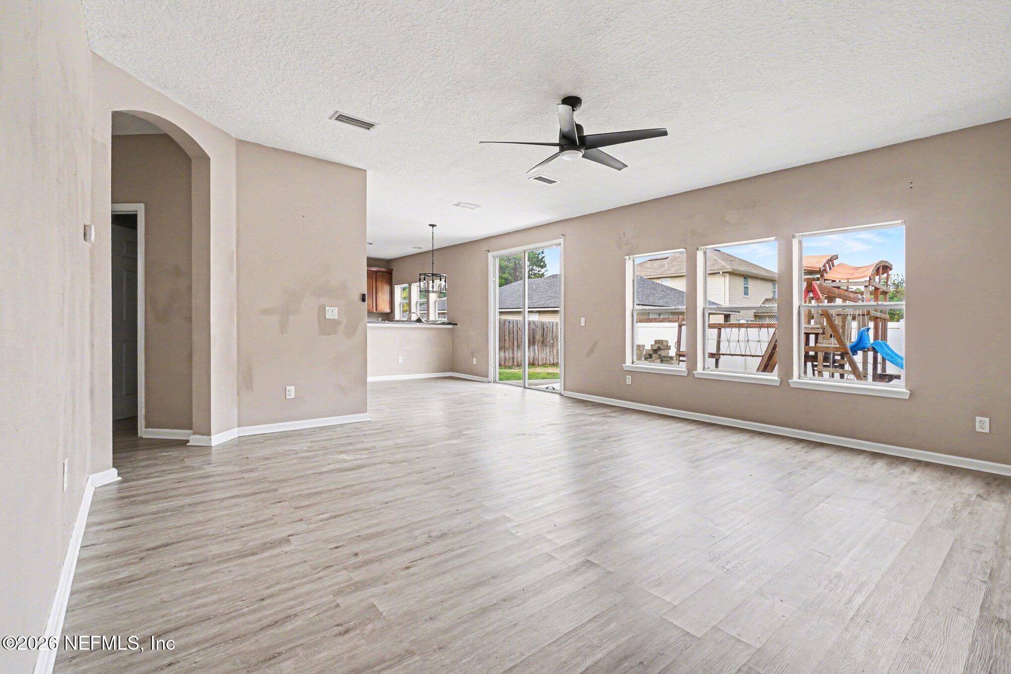 96039 Morton Lane Yulee, FL 32097 - Photo 8 of 27 a view of an empty room with a window and wooden floor