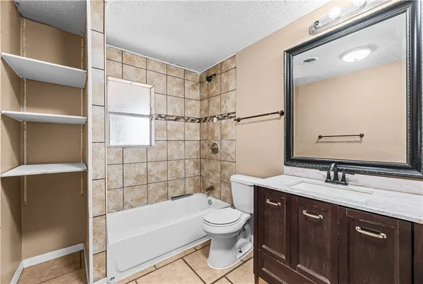 a bathroom with a double vanity sink toilet mirror and shower