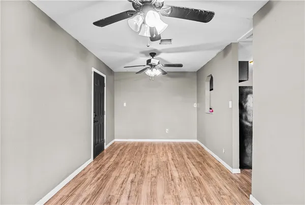 a view of a livingroom with a ceiling fan and wooden floor