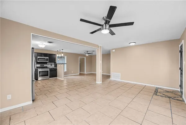 a view of a livingroom with a ceiling fan and window