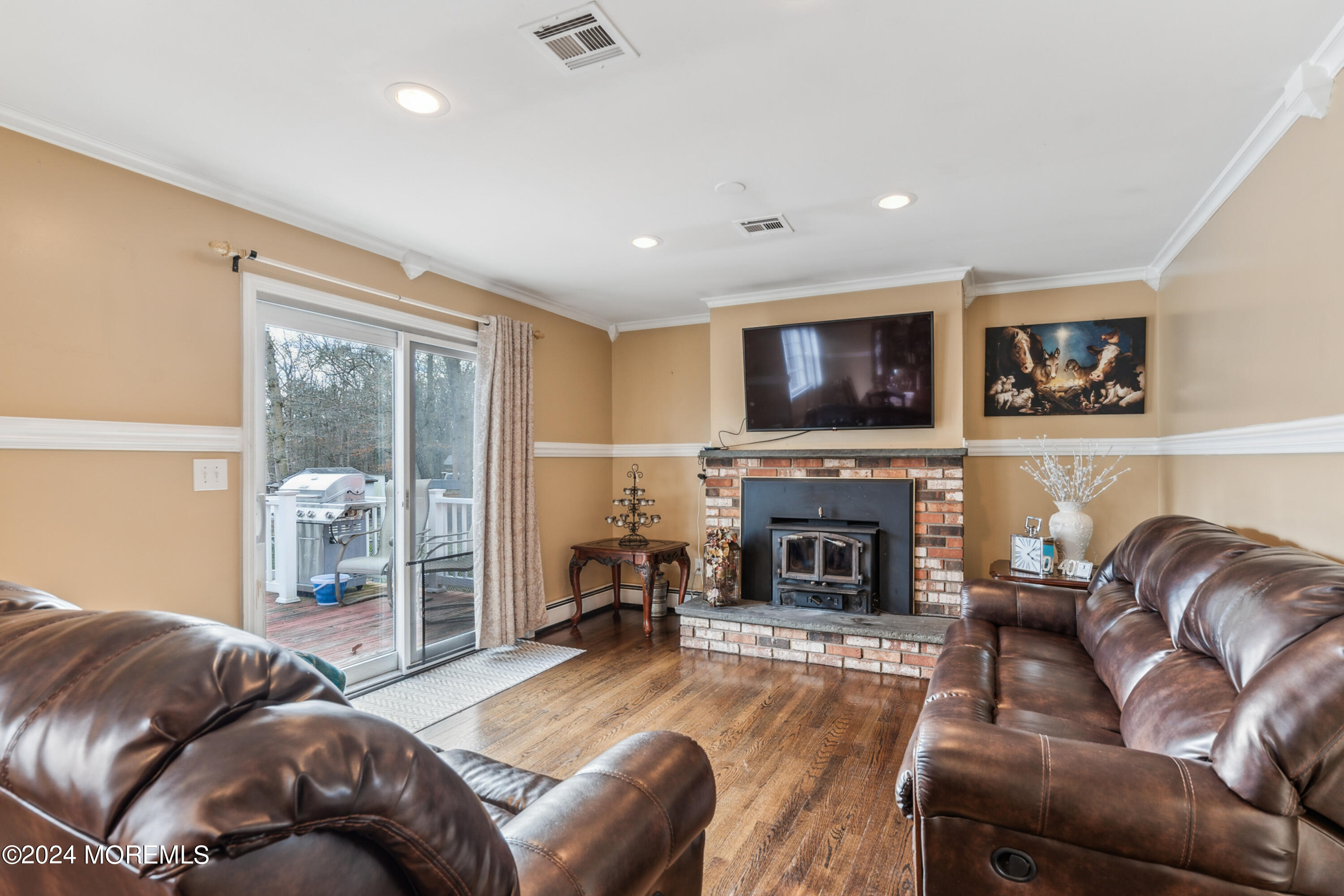 112 Porter Road Howell, NJ 07731 - Photo 10 of 39 a living room with furniture a fireplace and a flat screen tv