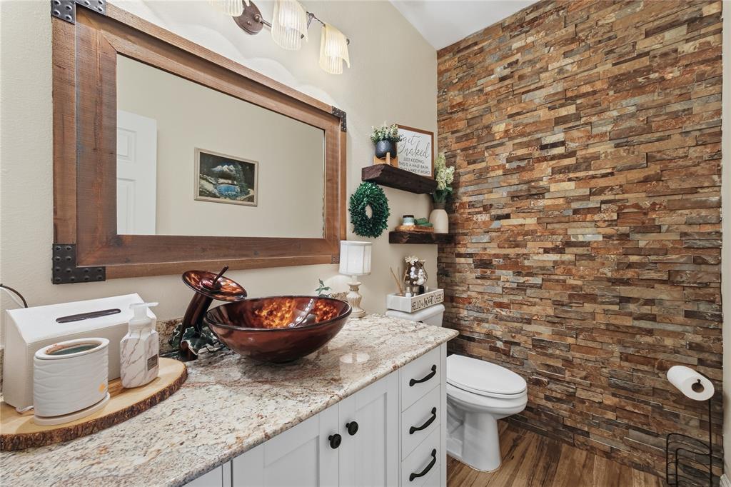 5262 Rio Vista Malakoff, TX 75148 - Photo 21 of 29 a bathroom with a granite countertop toilet and a sink