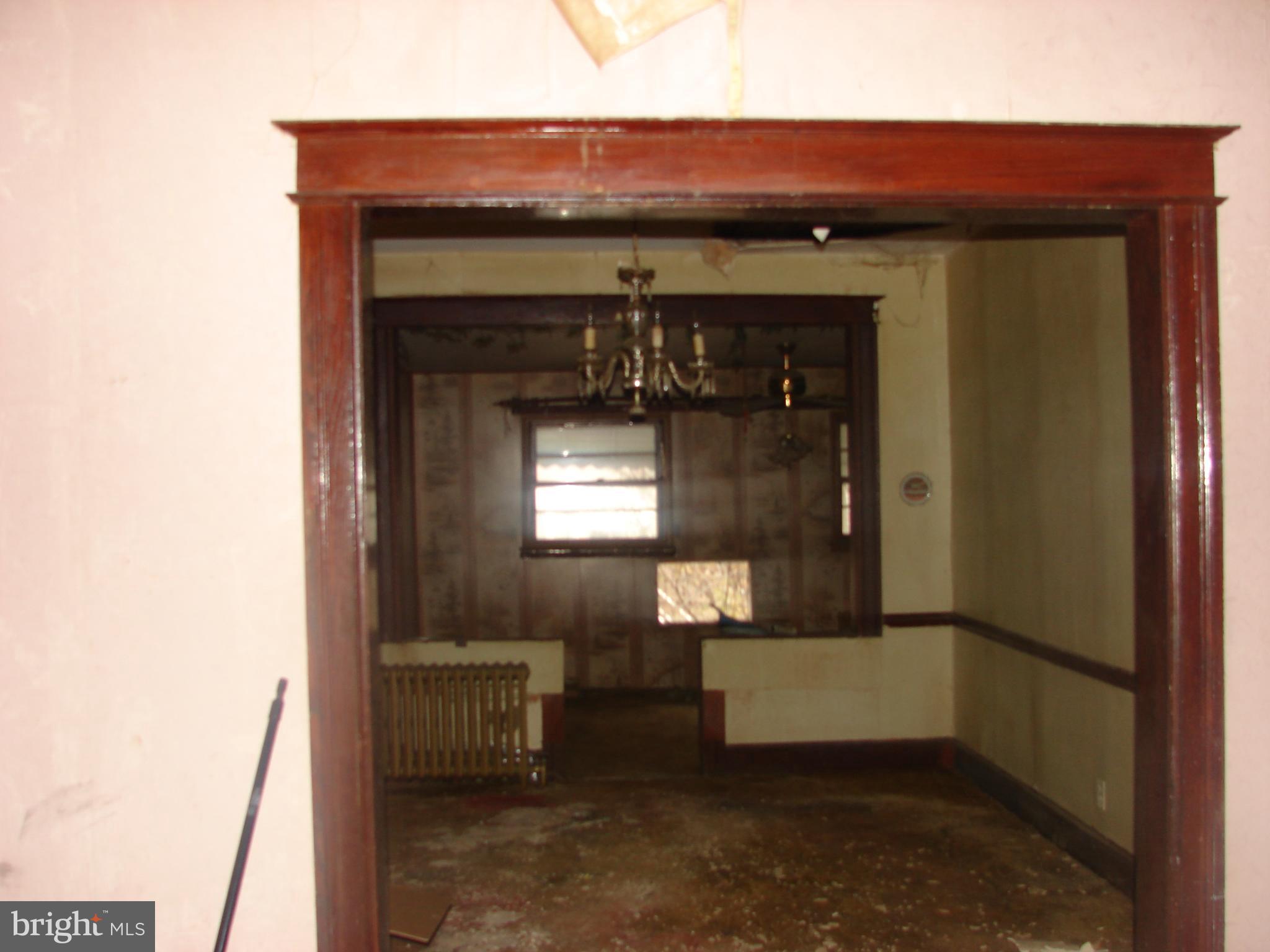 415 Farragut Street Northwest Washington, DC 20011 - Photo 10 of 27 a hallway with a fireplace and cabinets