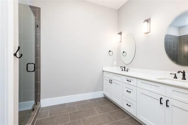 a bathroom with a glass shower door