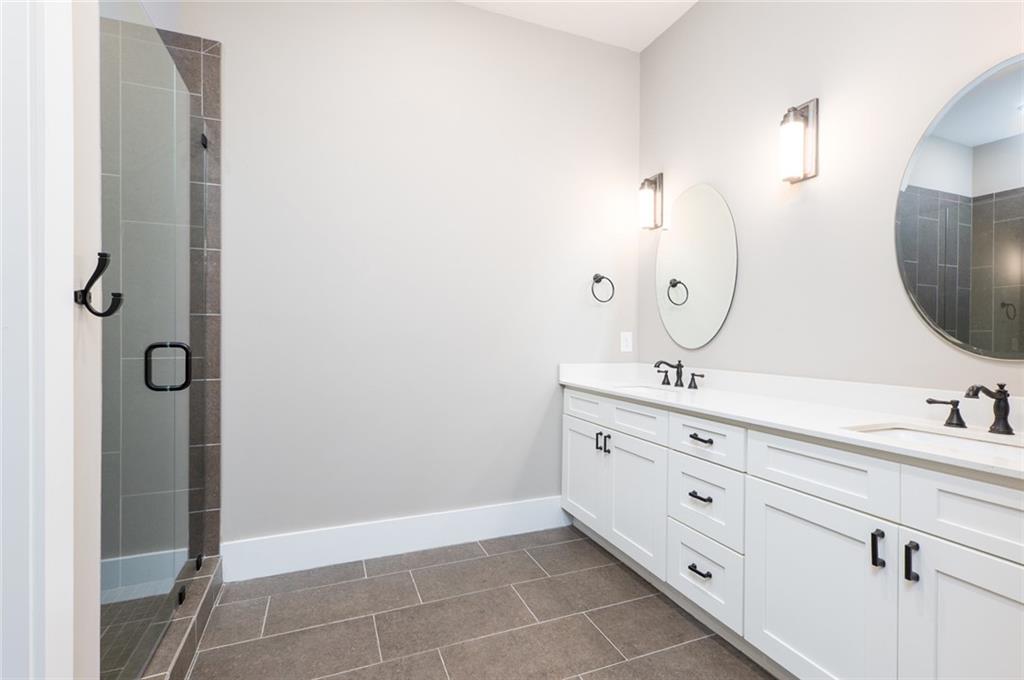 116 West Main Street, Unit 2A Blue Ridge, GA 30513 - Photo 9 of 14 a bathroom with a double vanity sink mirror and
