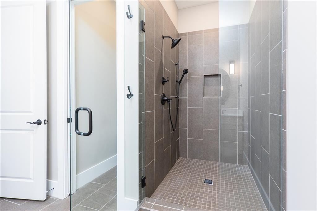 116 West Main Street, Unit 2A Blue Ridge, GA 30513 - Photo 10 of 14 a bathroom with a glass shower door