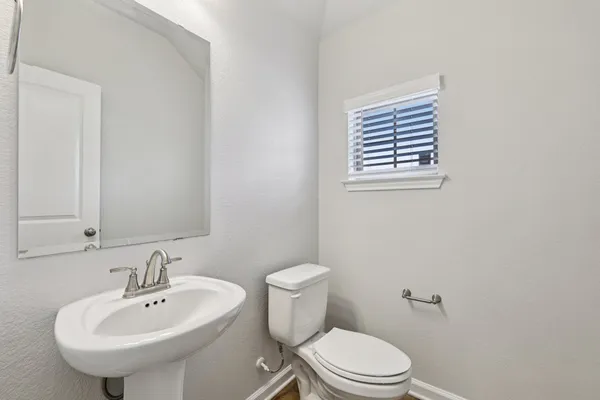 a view of a room with rack on the wall and a window