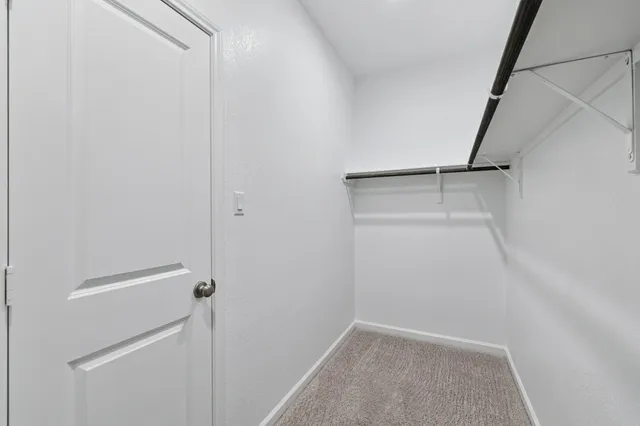 a spacious bathroom with a double vanity sink a mirror and a shower