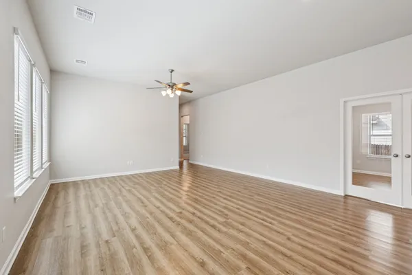 wooden floor in an empty room with a window