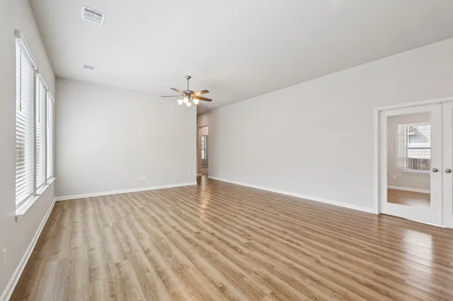 wooden floor in an empty room with a window