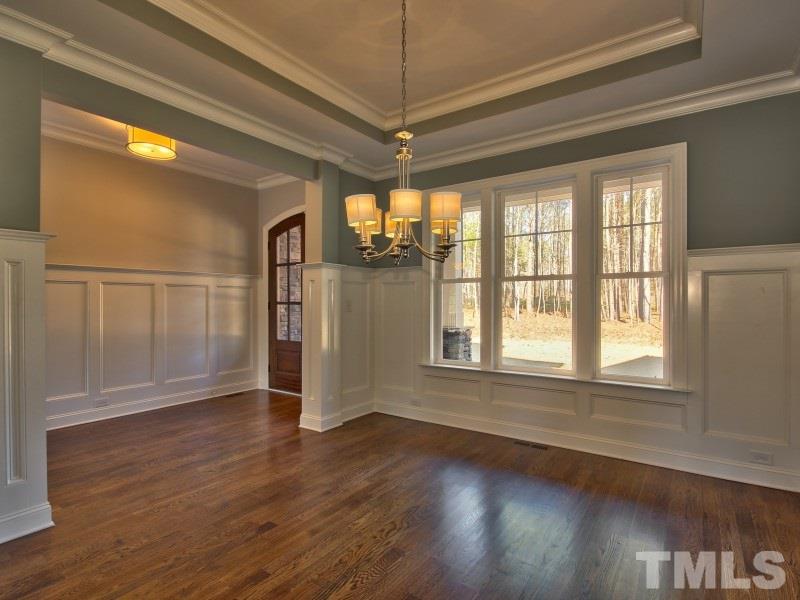2117 Old Sorrell Road Apex, NC 27539 - Photo 3 of 25 Elegant formal dining room with tray ceiling and wainscoting. The perfect place to entertain guests!