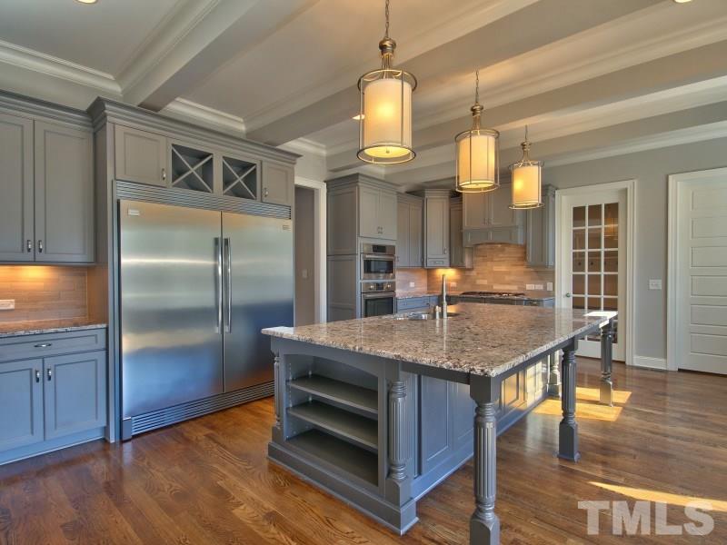 2117 Old Sorrell Road Apex, NC 27539 - Photo 5 of 25 Gourmet Kitchen w/ large center island, great cabinet storage, gas cooktop, walk in pantry, breakfast & beamed ceiling.