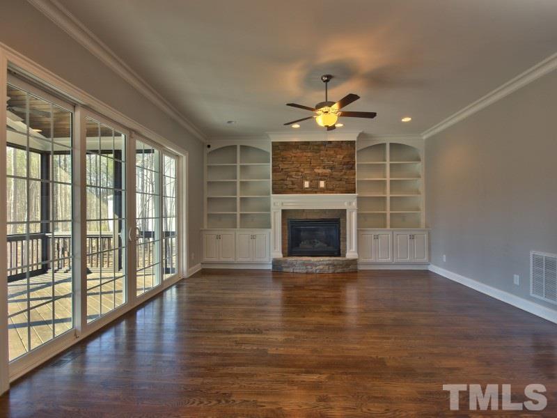 2117 Old Sorrell Road Apex, NC 27539 - Photo 8 of 25 Family Room features stone fireplace, great natural light and built ins.