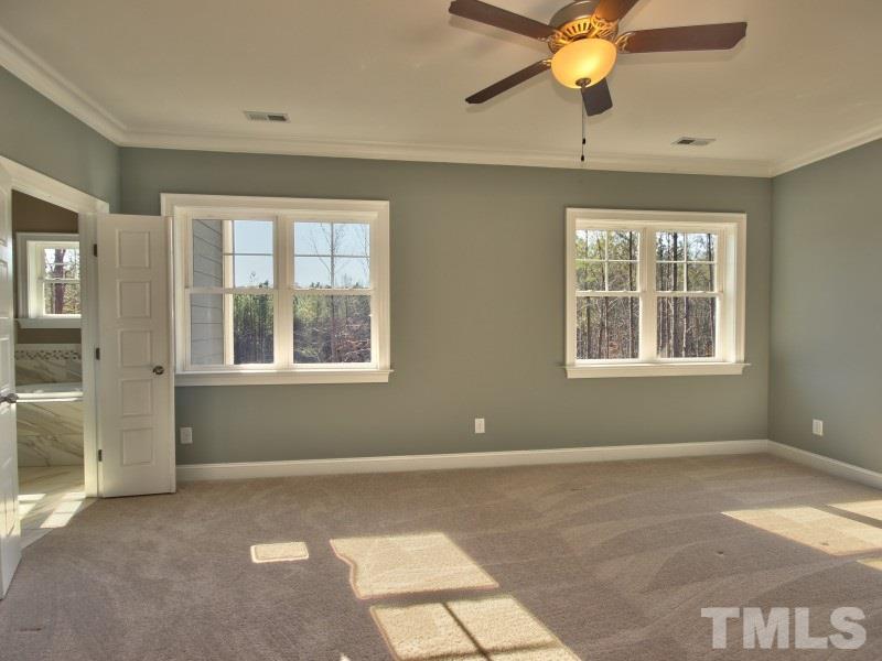2117 Old Sorrell Road Apex, NC 27539 - Photo 9 of 25 Spacious Master Suite with custom walk in closet and ceiling fan.