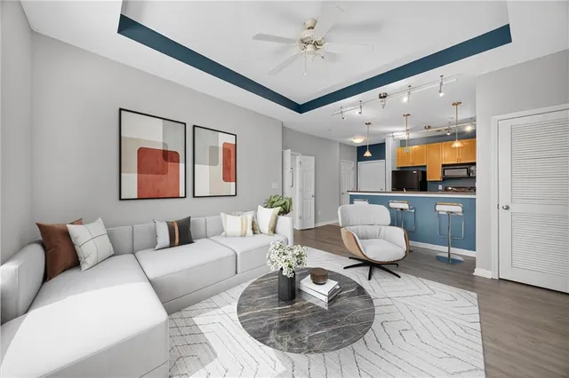 a living room with furniture and wooden floor