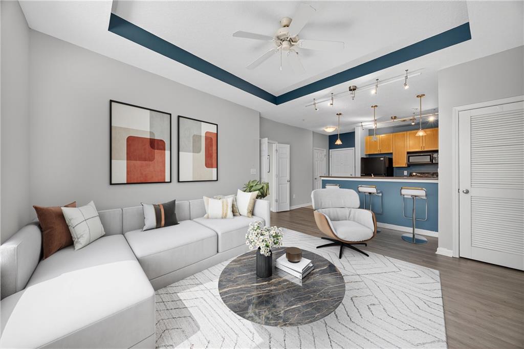 a living room with furniture and wooden floor