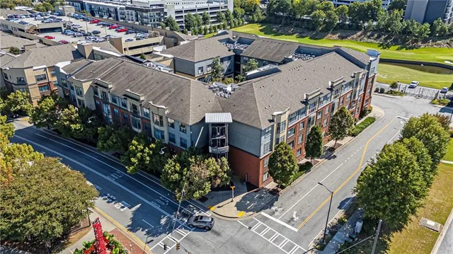 an aerial view of a house with a garden and lake view