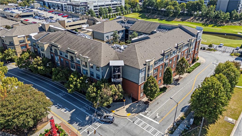 400 17th Street Northwest, Unit 2406 Atlanta, GA 30363 - Photo 13 of 16 an aerial view of a house with a garden and lake view