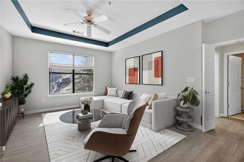 400 17th Street Northwest, Unit 2406 Atlanta, GA 30363 - Photo 2 of 16 a living room with furniture two window and a potted plant