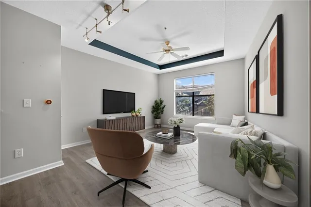 a living room with furniture a flat screen tv and a window