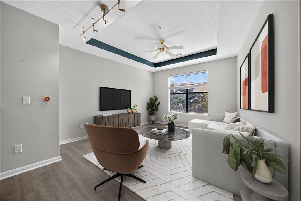 400 17th Street Northwest, Unit 2406 Atlanta, GA 30363 - Photo 3 of 16 a living room with furniture a flat screen tv and a window