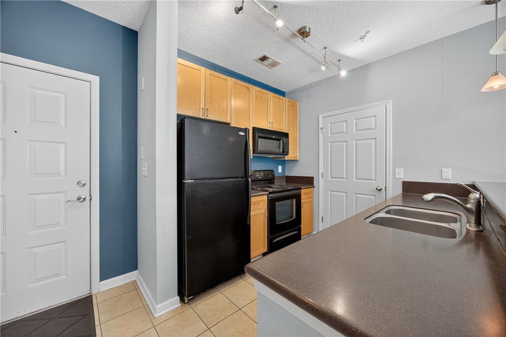 400 17th Street Northwest, Unit 2406 Atlanta, GA 30363 - Photo 5 of 16 a kitchen with a refrigerator and a sink