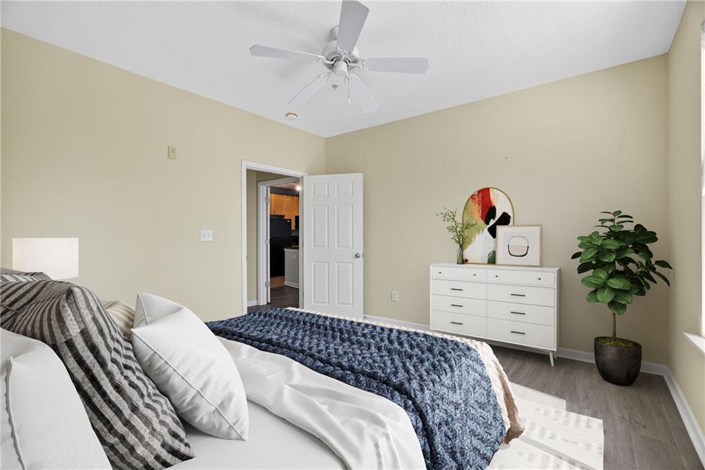 400 17th Street Northwest, Unit 2406 Atlanta, GA 30363 - Photo 7 of 16 a bedroom with a bed and a chandelier