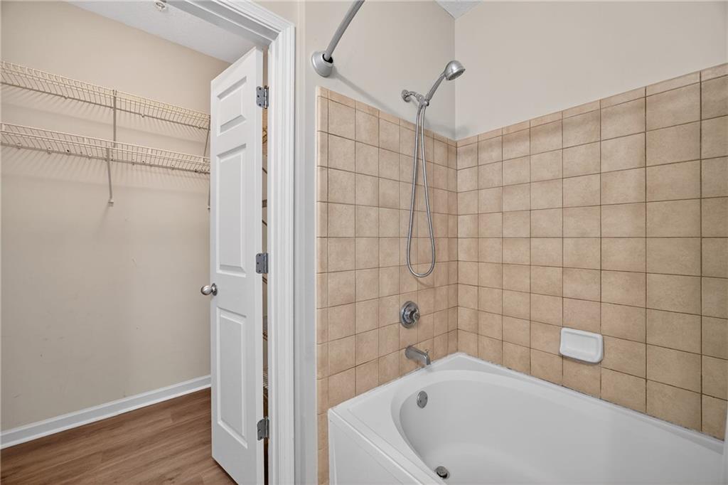 400 17th Street Northwest, Unit 2406 Atlanta, GA 30363 - Photo 8 of 16 a bathroom with a bathtub and shower